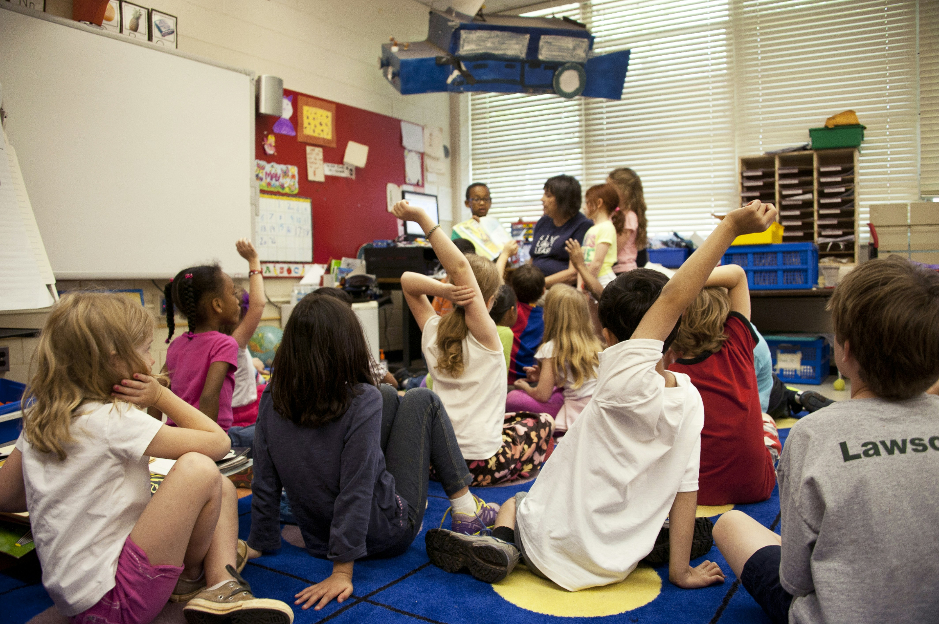 Children working together on an art project in a bright classroom